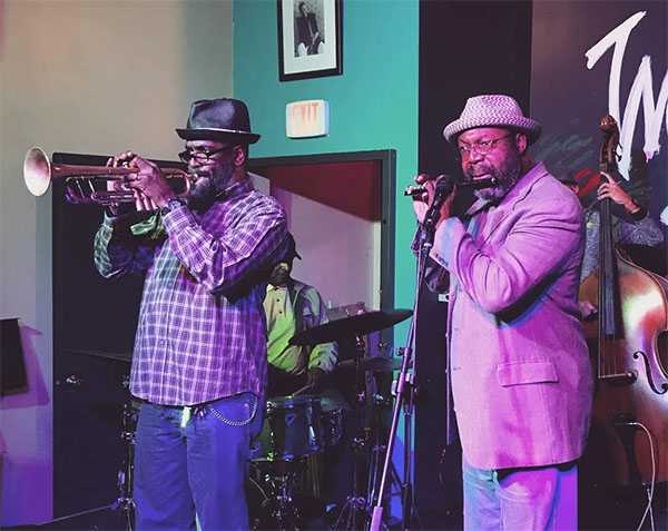 Rafiq (trumpet) and Sean “Doc” Johnson (piccolo) playing at The World Stage Thursday Jazz Jam Session | Photo: @driftingonareed, Instagram